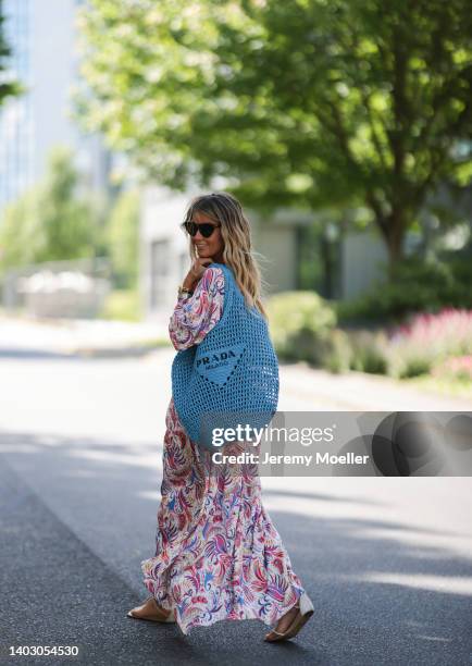 Gitta Banko seen wearing a Bottega Veneta sunglasses, a long maxi floral dress from Dea Kudibal with long sleeves, rhinestone sandals from Aminah...