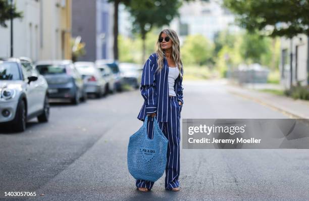 Gitta Banko seen wearing a Ray Ban sunglasses, a white tank top, a blue/white striped cotton pyjama set from Yaitte, rhinestone sandals from Aminah...