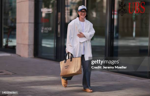 Maria Barteczko seen wearing a white logo baseball cap from Source Unknown, a black oversized Aviator glasses from Victoria Beckham, a white...