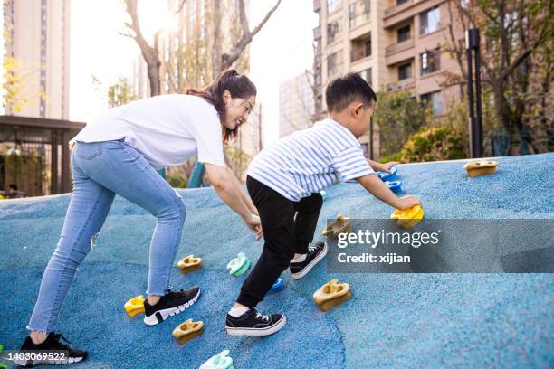 little boy climbs with mother - extreme sports kids stock pictures, royalty-free photos & images