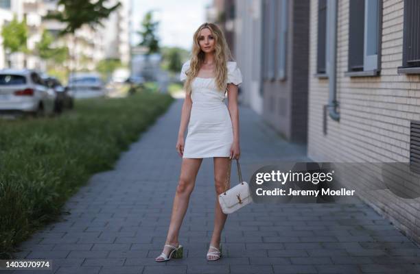 Anna Hiltrop seen wearing a white short dress from Zara, a white Yves Saint Laurent bag and white heels on June 11, 2022 in Dusseldorf, Germany.