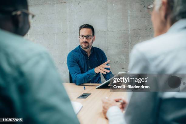 meeting in office - serious interview stock pictures, royalty-free photos & images