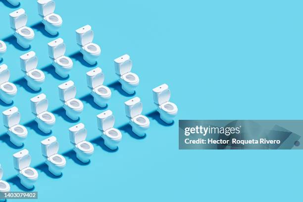 white toilet bowl on blue background, 3d render - toilet bowl bathroom stock pictures, royalty-free photos & images