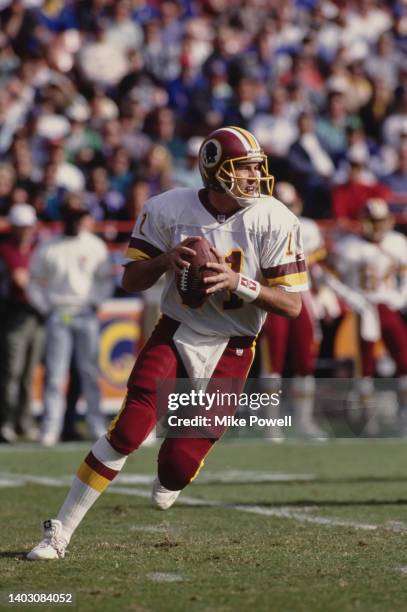 Mark Rypien, Quarterback for the Washington Redskins runs the ball during the National Football Conference West Division game against the Los Angeles...