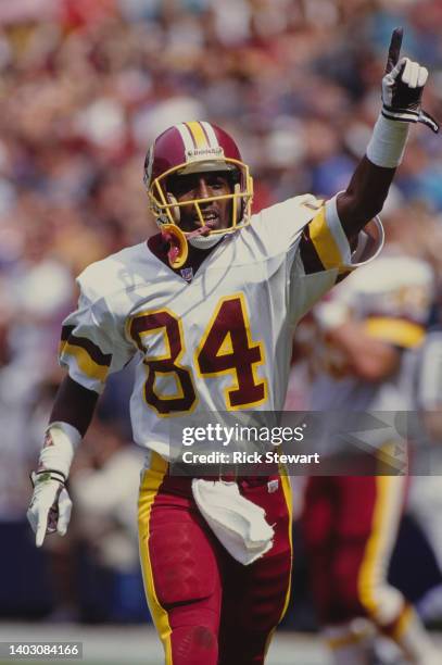 Gary Clark, Wide Receiver for the Washington Redskins gives the number one sign after scoring a touchdown during the National Football Conference...