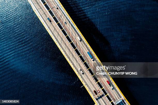 drone view of ting kau bridge in hong kong - bridge low angle view stock pictures, royalty-free photos & images