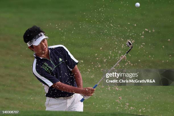 Kodai Ichihara of Japan plays out of the bunker on the 18th green during round two of The Open Championship International Final Qualifying Asia at...