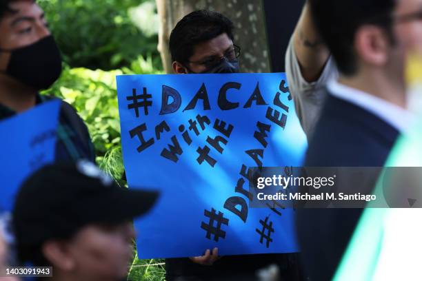 People gather for a rally to celebrate the 10th anniversary of the Deferred Action for Childhood Arrivals in Battery Park on June 15, 2022 in New...