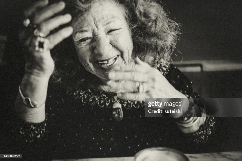 The hearty laugh of the elegant old lady.