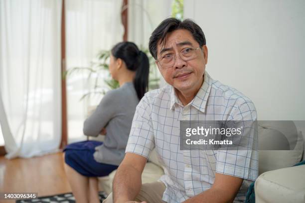 upset senior man has argument with wife. - asian couple arguing stock-fotos und bilder