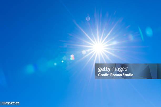 sunburst with lens flare. clear sky, sun, blue sky - sun stock pictures, royalty-free photos & images