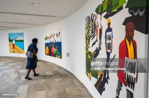 Woman looks at the pantings of the artist Richard Bell at the Fridericianum during the first preview day at the documenta 15 modern art fair on June...