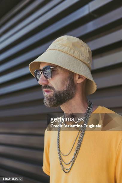 Raimondo Rossi wearing D&G necklace, Bricklane sunglasses, Yohji Yamamoto shoes, Zara pants, Cos t-shirt Undefeated hat at the Pitti Immagine Uomo...