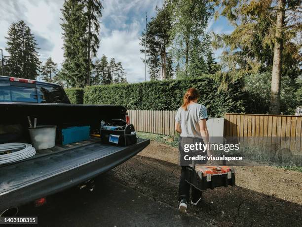 female electrician picking tools from car trunk - tool box stock pictures, royalty-free photos & images