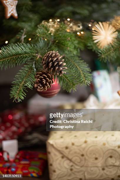 fir cone on decorated christmas tree - conifer cone stock pictures, royalty-free photos & images