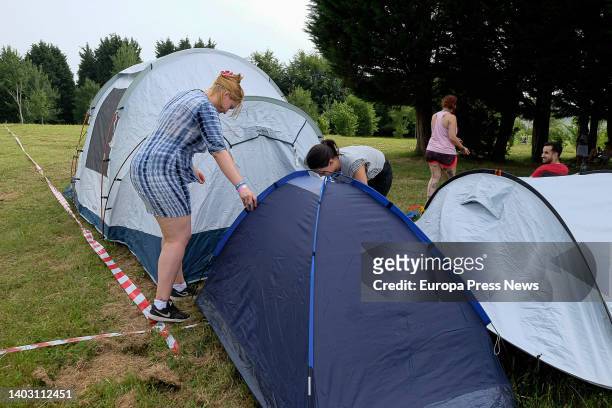 Several people set up tents in the camping area at the Oson de Camiño festival, at Monte do Gozo, on 15 June, 2022 in Santiago de Compostela, A...