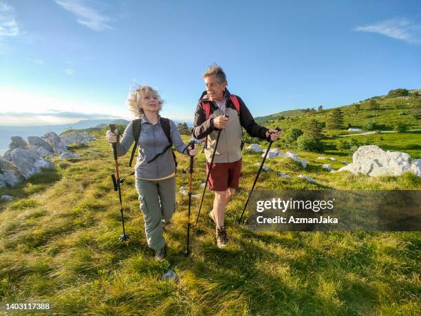 a senior heterosexual couple hiking in the mountains - slovenia hiking stock pictures, royalty-free photos & images