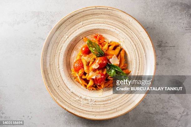 penne arrabiata, pasta with tomato sauce - pasta tomato basil stockfoto's en -beelden