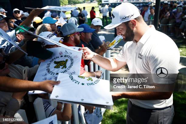 Jon Rahm of Spain signs his autograph for a fan during a practice round prior to the 122nd U.S. Open Championship at The Country Club on June 15,...