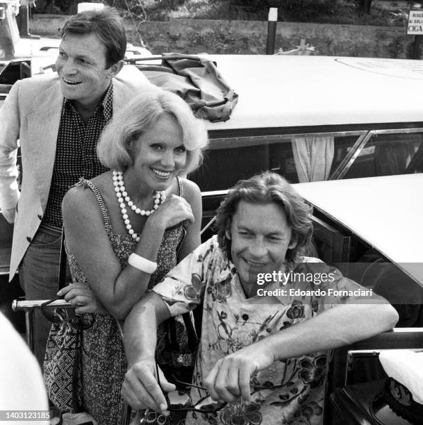 The German dancer Ellen Kessler with the Italian actor and her boyfriend Umerto Orsini and the Austrian actor Helmut Berger . September 01, 1980.