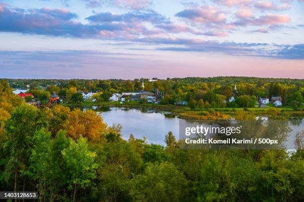 scenic view of lake against small town and sky during autumn,rideau lakes,ontario,canada - ontario canada stock pictures, royalty-free photos & images