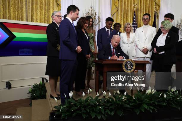 President Joe Biden signs an executive order on advancing equality for LGBTQI+ individuals as Transportation Secretary Pete Buttigieg , Vice...