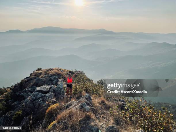 young woman on summit of mountain above valley - corsica stockfoto's en -beelden