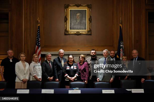 Bipartisan group of senators pose for photographs with a delegation from the Ukrainian parlament before a meeting in the Mansfield Room at the U.S....