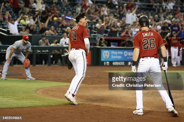 Josh Rojas of the Arizona Diamondbacks celebrates after scoring a run against the Cincinnati Reds during the eighth inning of the MLB game at Chase...