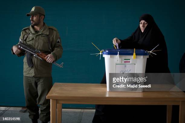 An Iranian woman casts her ballot in a polling station at the Massoumeh shrine on March 2, 2012 in the religious city 130 kms east of Tehran, Qom,...