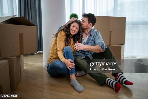 happy young couple feeling excited for moving into their new home - home sweet home stockfoto's en -beelden