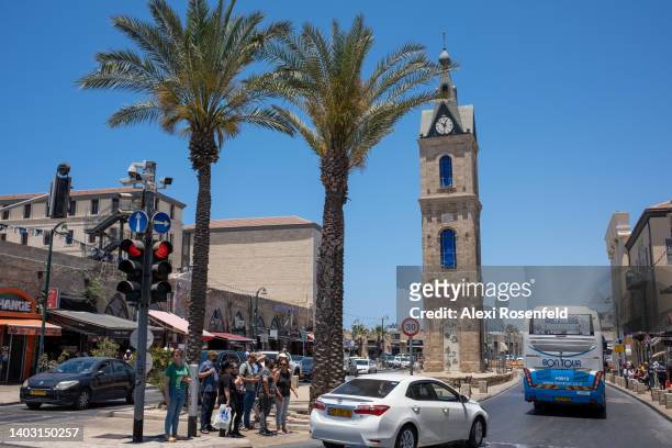 People walks near the clock tower in the Old City of Jaffa on June 15, 2022 in Jaffa, Israel. On April 24th Israel removed all COVID-19 restrictions...