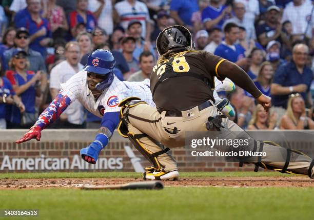 Jonathan Villar of the Chicago Cubs scores against Jorge Alfaro of the San Diego Padres in the second inning at Wrigley Field on June 15, 2022 in...