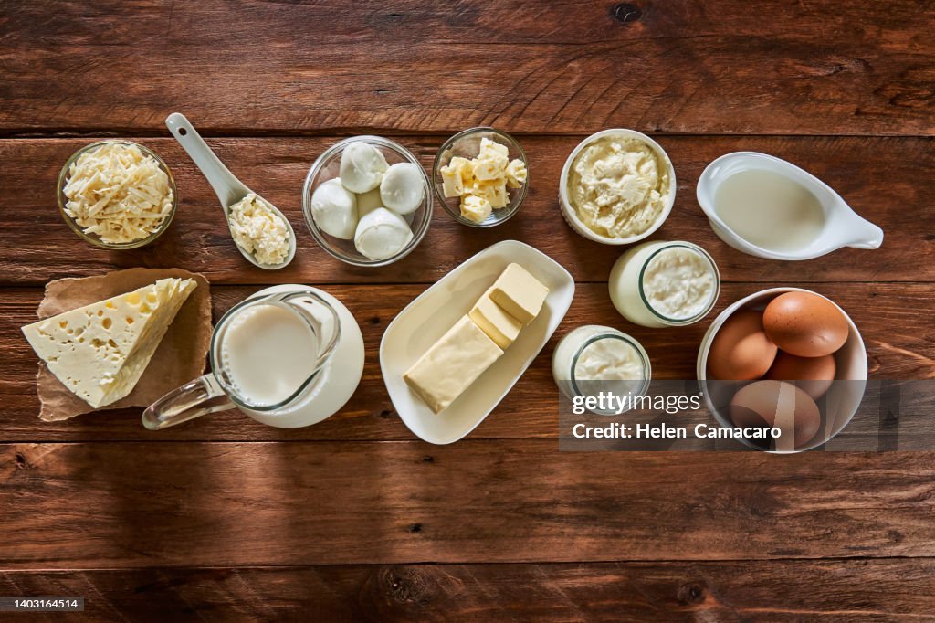 Top view of dairy products on rustic wooden table.