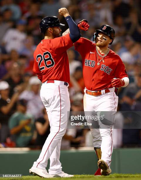 Martinez of the Boston Red Sox congratulates teammate Alex Verdugo after he hit a two run home run in the sixth inning against the Oakland Athletics...