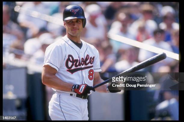 Shortstop Cal Ripken Jr. Of the Baltimore Orioles stands with bat in hand during a game against the California Angels at Oriole Park at Camden Yards...