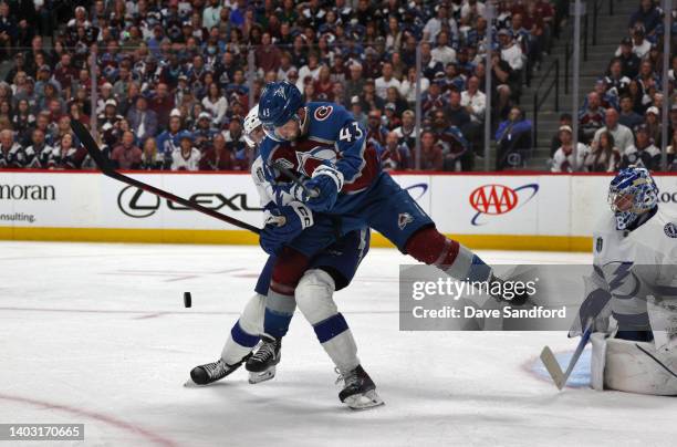 Darren Helm of the Colorado Avalanche tries for the deflection on net as Nicholas Paul and goaltender Andrei Vasilevskiy of the Tampa Bay Lightning...