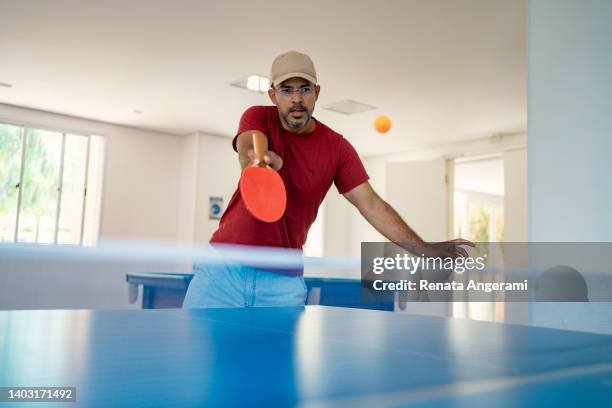 mature man playing  table tennis - men's table tennis stock pictures, royalty-free photos & images