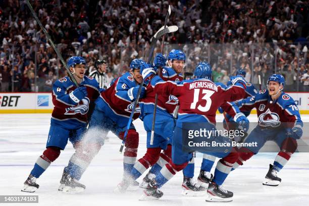 Andre Burakovsky of the Colorado Avalanche celebrates with teammates after scoring a goal against Andrei Vasilevskiy of the Tampa Bay Lightning...