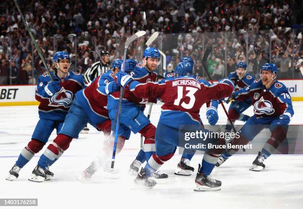 Andre Burakovsky of the Colorado Avalanche celebrates with teammates after scoring a goal against Andrei Vasilevskiy of the Tampa Bay Lightning...