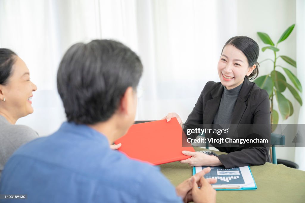 Insurance consultant visiting senior couple at home