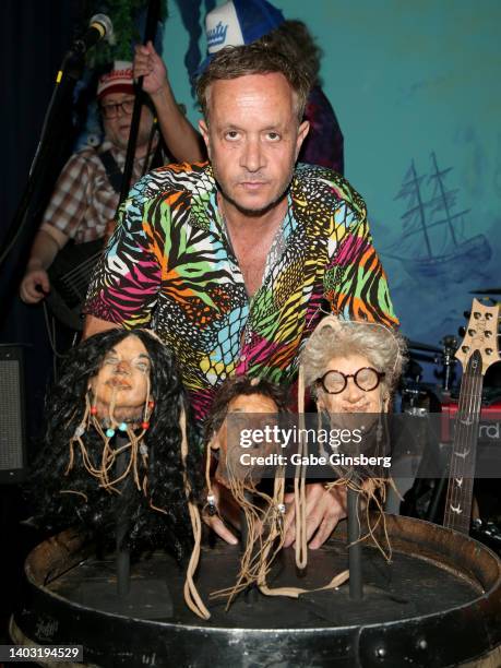 Actor and comedian Pauly Shore poses with sculptures of a shrunken heads in the likeness of his family, Mitzi Shore, Pauly Shore and Sammy Shore,...