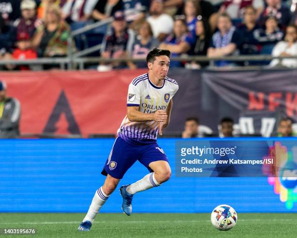 Mauricio Pereyra of Orlando City brings the ball forward during a game between Orlando City SC and New England Revolution at Gillette Stadium on June...