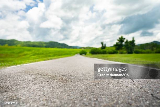 selective focus empty open road view with dramatic cloud and copy space - road map stock-fotos und bilder