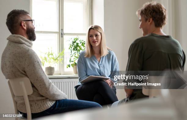 psychological woman doing group therapy. - rehabilitation meeting stock-fotos und bilder