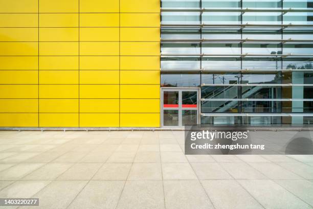 modern building with glass wall in modern city - yellow door stock pictures, royalty-free photos & images