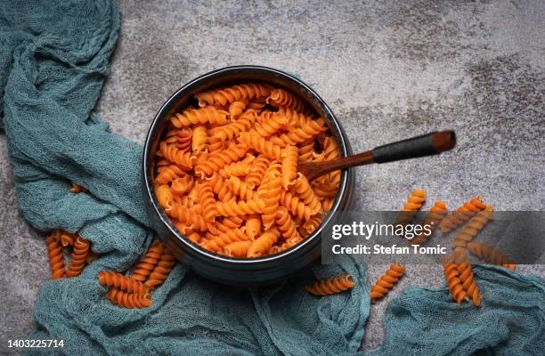 italian orange spiral pasta - lentils stock pictures, royalty-free photos & images