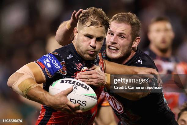 Jack De Belin of the Dragons is tackled by Thomas Burgess of the Rabbitohs during the round 15 NRL match between the St George Illawarra Dragons and...