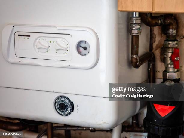 small to medium combi boiler heating system found in typical family home terrace house in uk. - bollitore foto e immagini stock