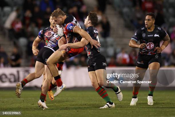 Jack De Belin of the Dragons is tackled during the round 15 NRL match between the St George Illawarra Dragons and the South Sydney Rabbitohs at WIN...